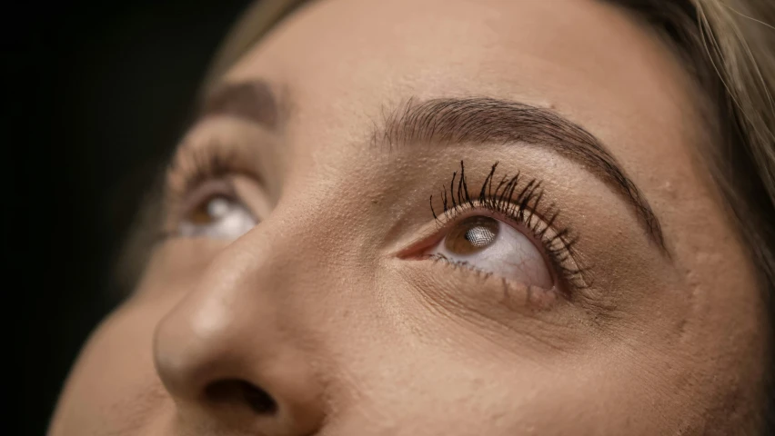 a close up of a woman with long eyelashes, trending on pexels, hyperrealism, big eyebrows, cinematic view from lower angle, shot on canon eos r5, photo realistic image