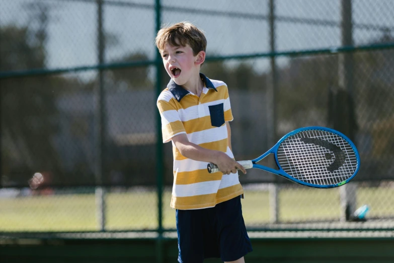 a young boy holding a tennis racquet on a tennis court, happening, shouting, promotional image, private school, thumbnail