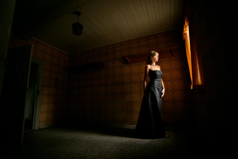 a woman in a black dress standing in a room, by Peter Churcher, art photography, medium format. soft light, wedding, night, long