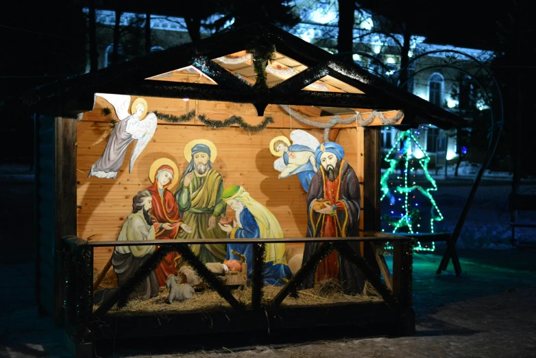 a nativity scene is lit up in the dark, a portrait, pexels, graffiti, in moscow centre, 👰 🏇 ❌ 🍃, square, a wooden