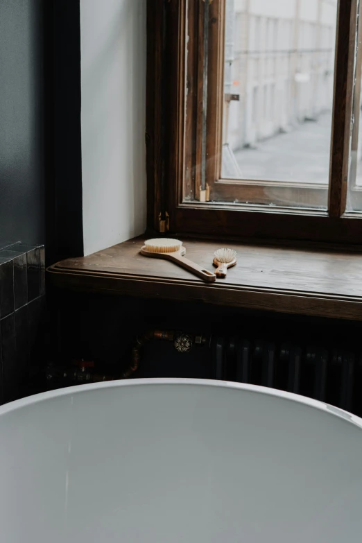 a white bath tub sitting in a bathroom next to a window, by Andries Stock, trending on unsplash, renaissance, on a wooden tray, flat brush, detailed product image, monocle