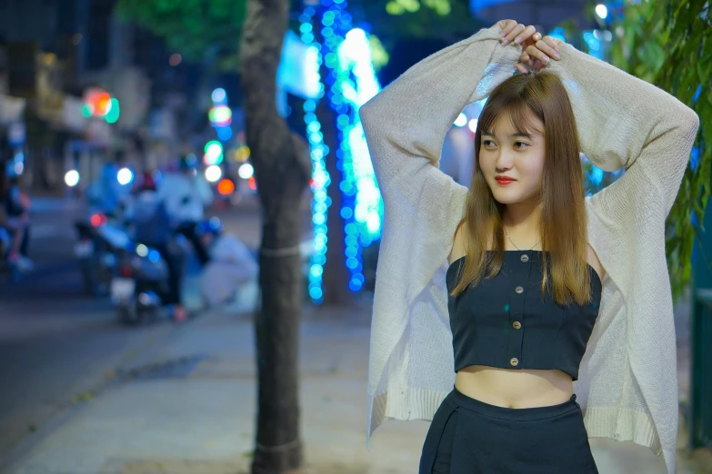 a woman standing on a city street at night, inspired by Kim Jeong-hui, pexels contest winner, wearing a cropped top, vietnamese woman, young adorable korean face, avatar image