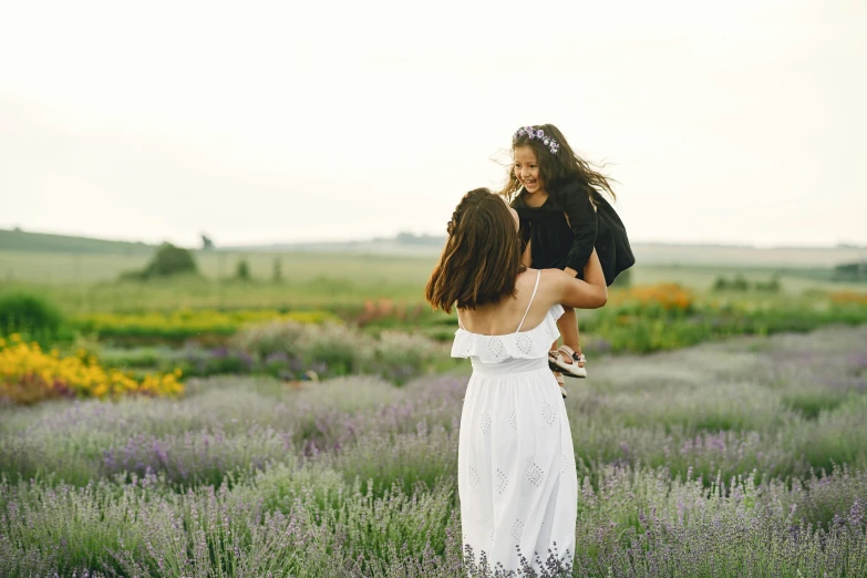 a woman holding a child in a lavender field, pexels contest winner, wearing a white sundress, afternoon hangout, excited, youtube thumbnail