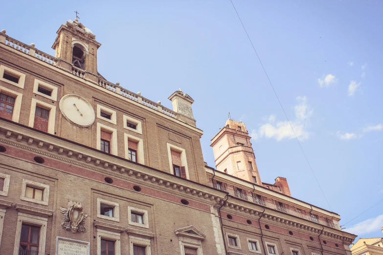 a large building with a clock on the front of it, a photo, pexels contest winner, neoclassicism, terracotta, castle towers, young handsome pale roma, upside - down building