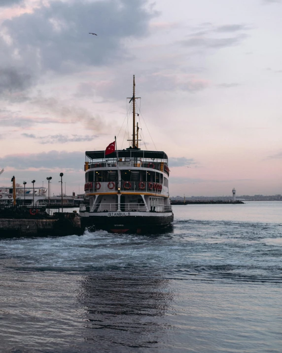 a large boat traveling across a body of water, by Carey Morris, pexels contest winner, hurufiyya, transgender, istanbul, low quality photo, thumbnail