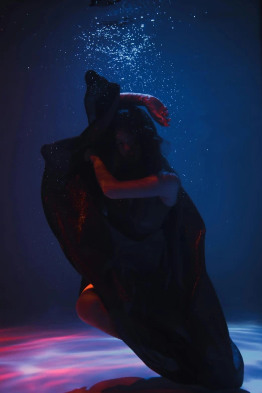 a person riding a skateboard under water, an album cover, unsplash, woman in black robes, draped in flowing fabric, underexposed, showstudio