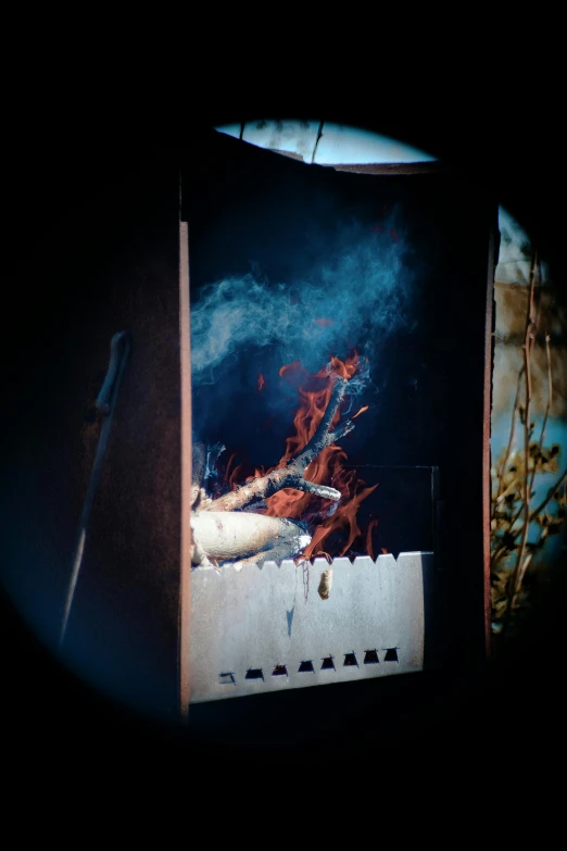 a close up of a stove with smoke coming out of it, inspired by Elsa Bleda, fire breathing geese, pinhole photo quality, at a campfire at night, slide show