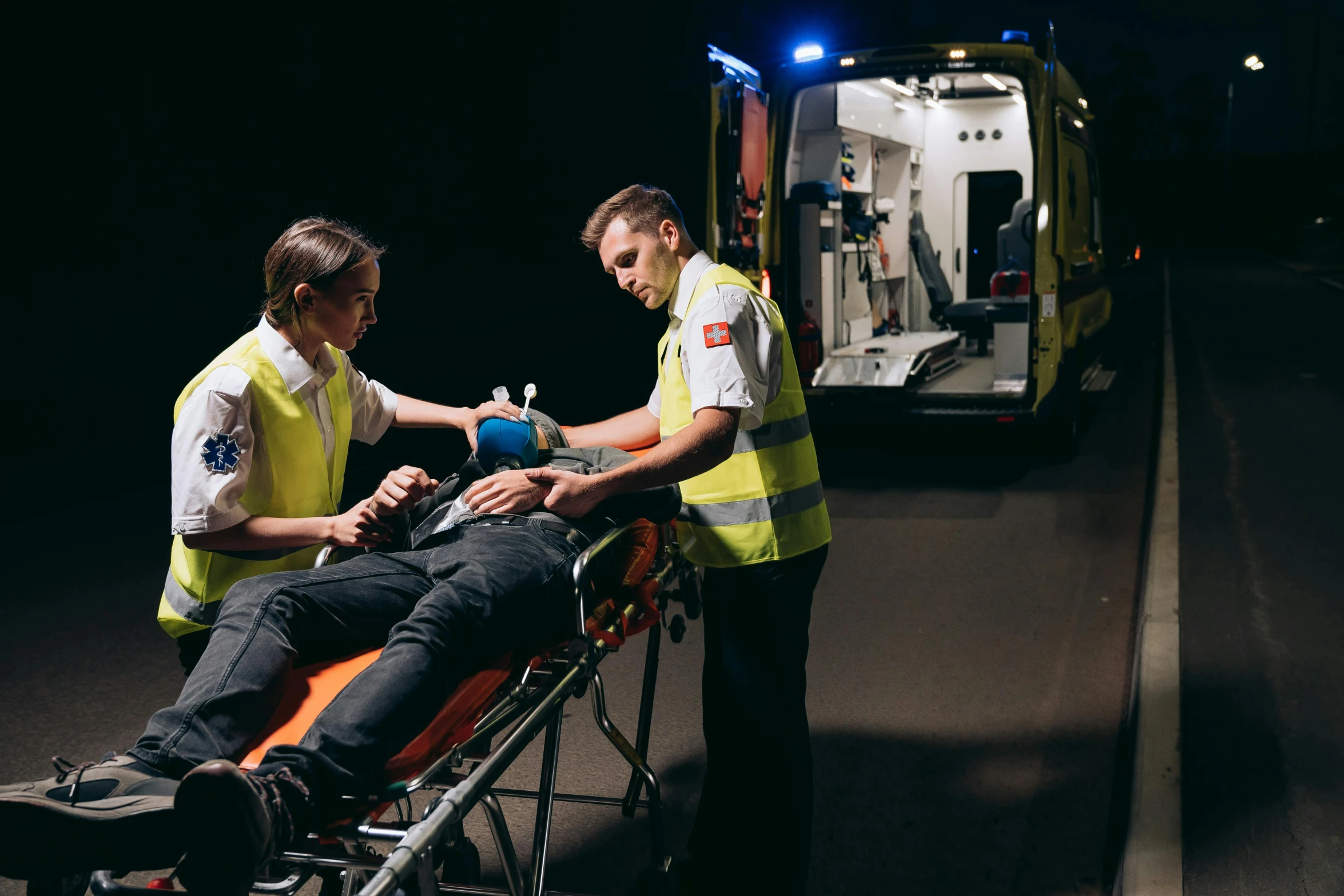 a couple of men standing next to a person on a stretcher, by Adam Marczyński, pexels, happening, night time footage, avatar image, ambulance, ( ultra realistic