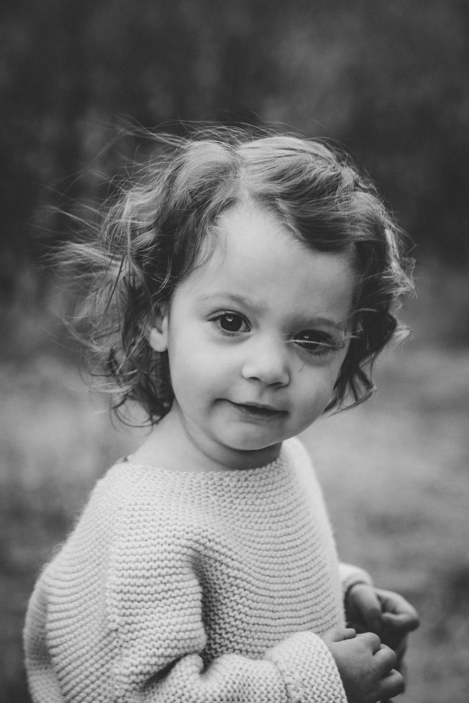 a black and white photo of a little girl, curls on top, uploaded, professional photo