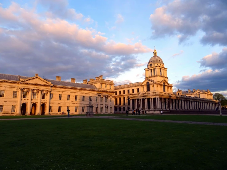 a large building sitting on top of a lush green field, inspired by William Hoare, pexels contest winner, academic art, at dusk at golden hour, square, cheerios, royal palace