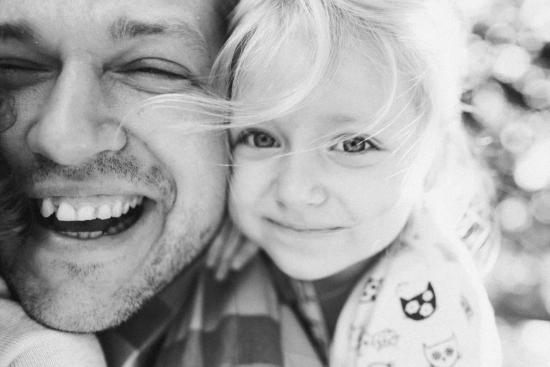 a black and white photo of a man and a little girl, a black and white photo, by Matt Cavotta, pexels, right - half a cheerful face, flattened, closeup, instagram picture