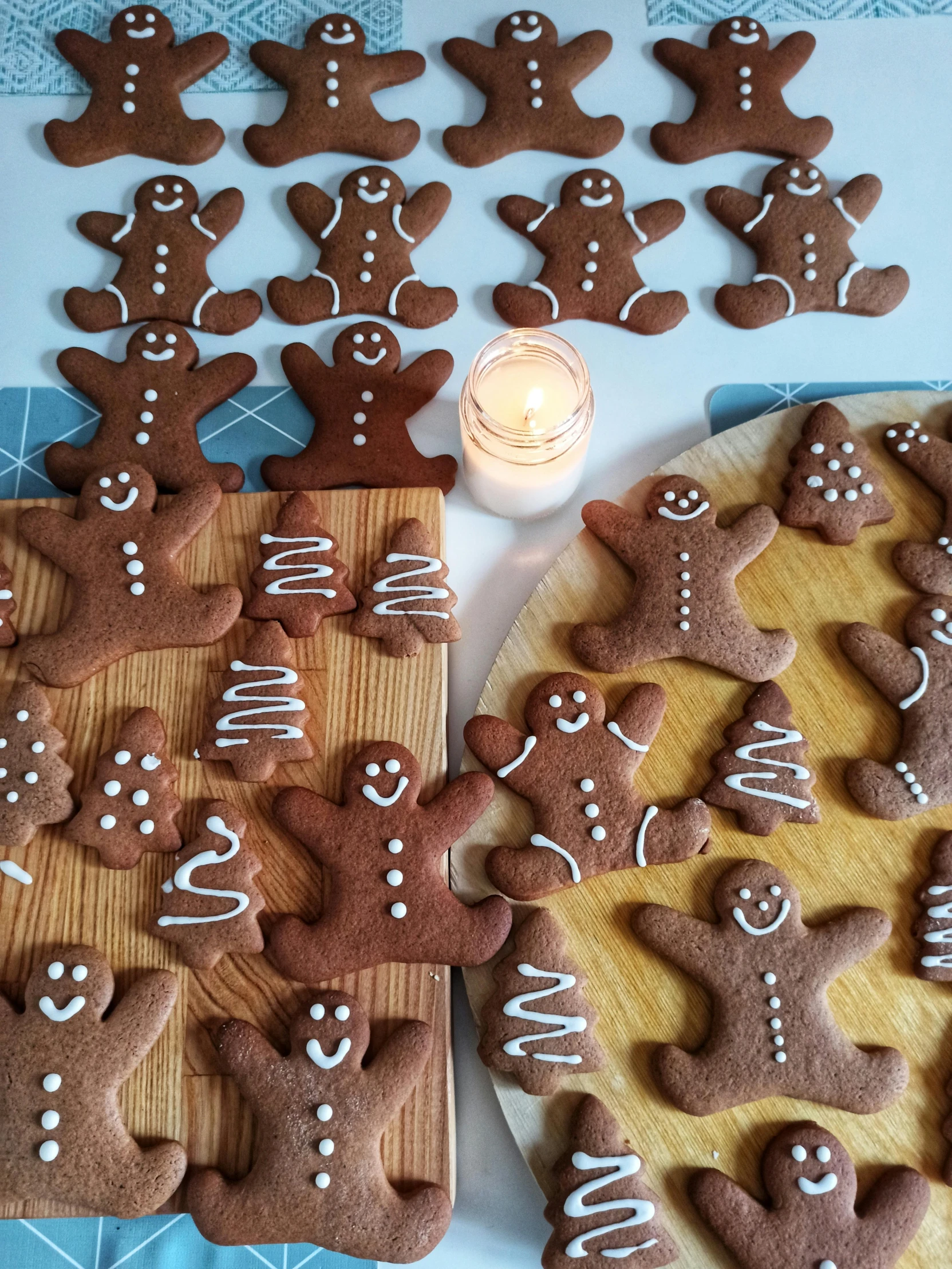 a table topped with lots of cookies next to a lit candle, reddit, process art, gingerbread people, thumbnail, healthy, 0