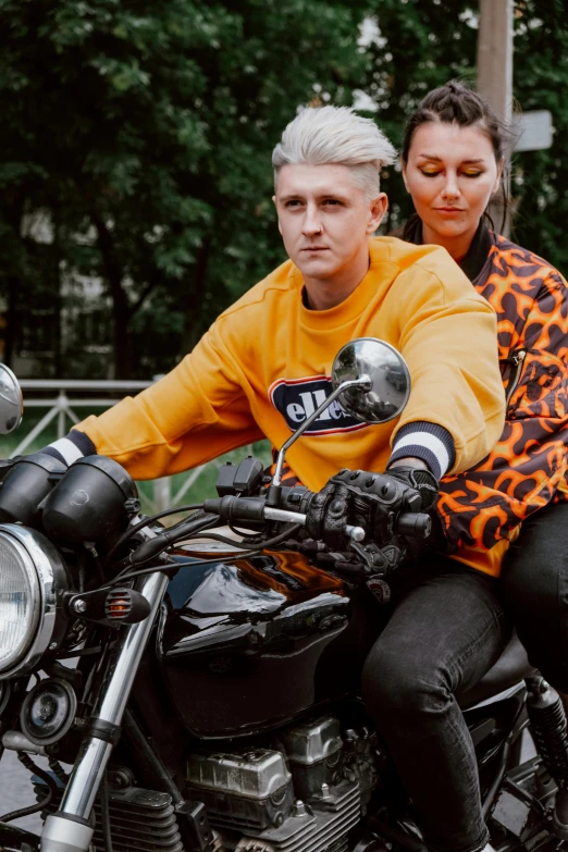 a man and a woman sitting on a motorcycle, a portrait, trending on pexels, trending on r/streetwear, anna nikonova aka newmilky, orange, high quality picture