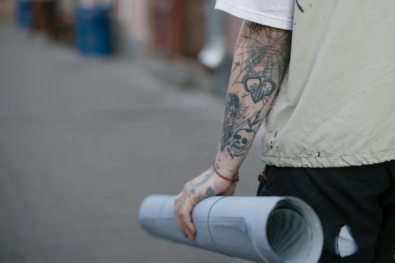a man walking down a street holding a roll of toilet paper, a tattoo, unsplash, blue print, mat drawing paper, with tattoos, architect