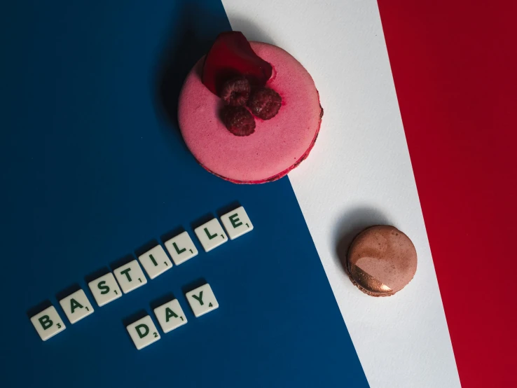 a pink donut sitting on top of a blue and white table, letterism, french flag, red castle in background, flatlay, macaron