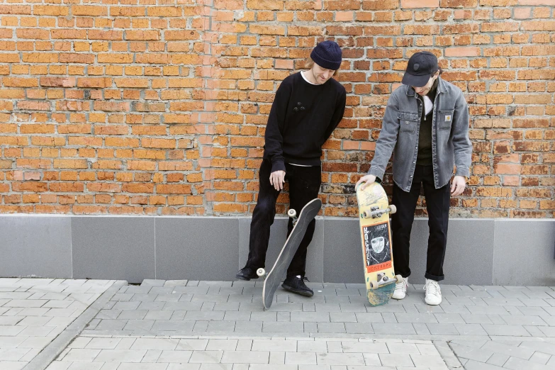 a couple of men standing next to each other with skateboards, a picture, brick, february), portrait image, guide