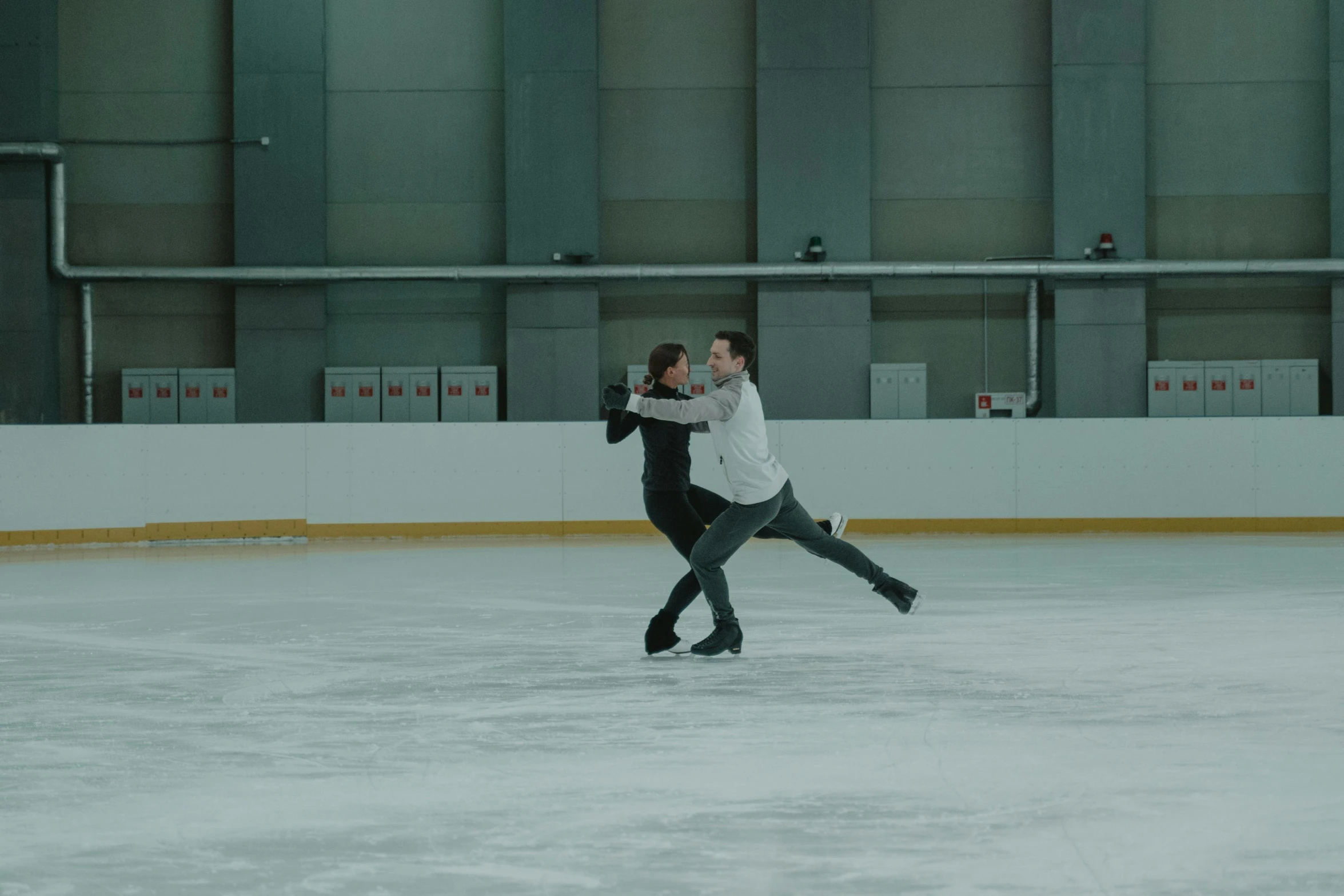 two people are skating on an ice rink, by Emma Andijewska, arabesque, 8 k movie still, shot on sony a 7, charli bowater and artgeem, **cinematic