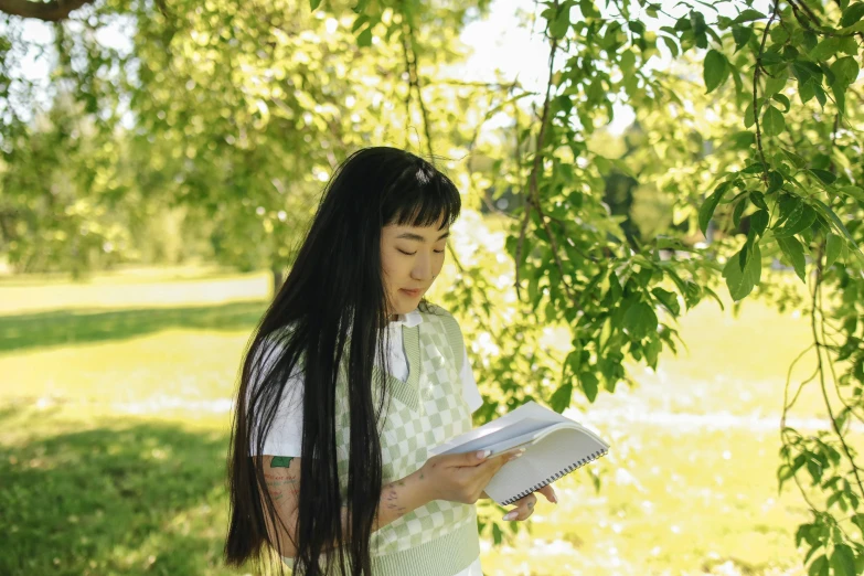 a woman reading a book under a tree, pexels contest winner, visual art, white hime cut hairstyle, holding notebook, female with long black hair, sydney park