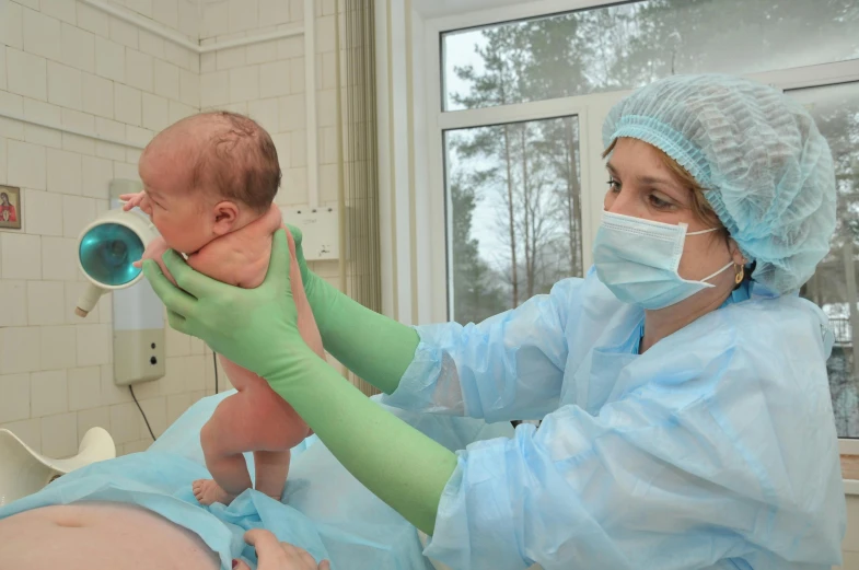 a woman in a hospital gown holding a baby, by Anna Füssli, trending on reddit, medical laboratory, silicone skin, sergey krasovskiy, thumbnail
