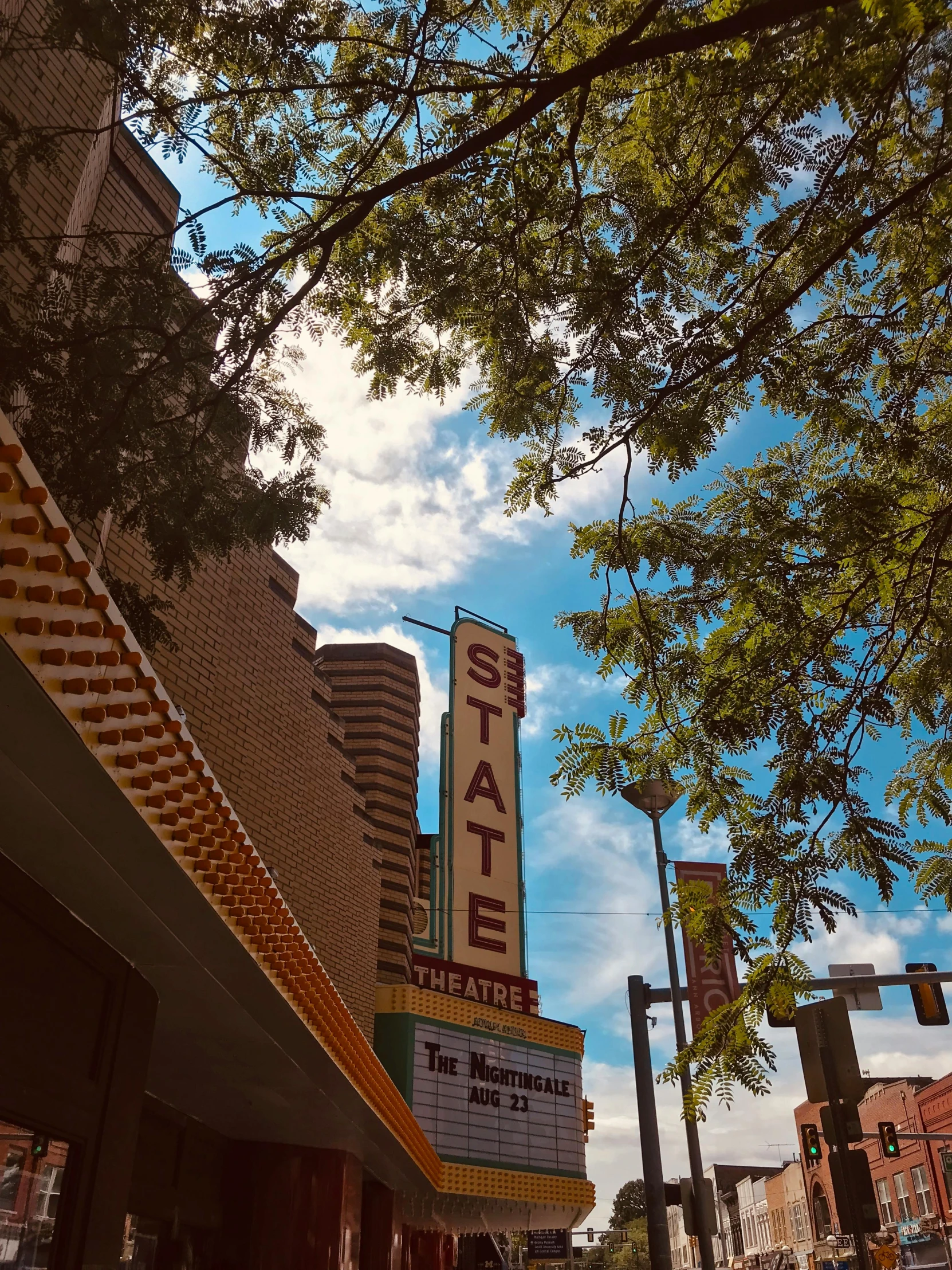 a large sign on the side of a building, a photo, by Ben Thompson, unsplash, renaissance, sitting in a movie theater, view from below, 🌸 🌼 💮, albuquerque