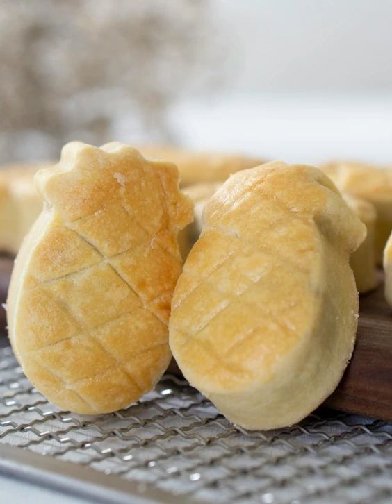 a bunch of bread sitting on top of a cutting board, profile image, pineapples, white ceramic shapes, thumbnail