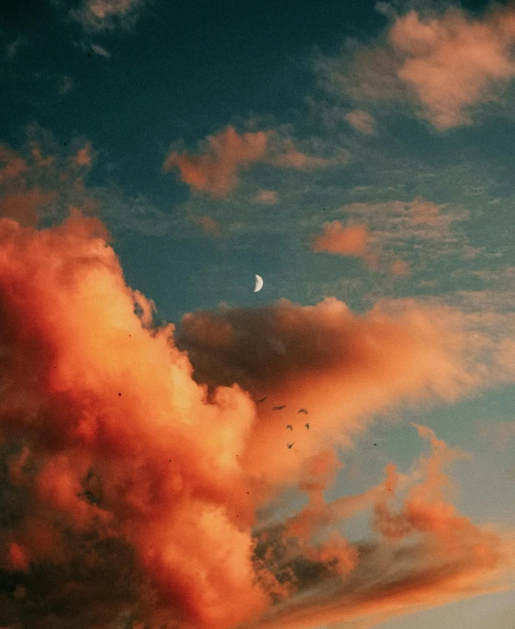 there is a plane that is flying in the sky, an album cover, inspired by Elsa Bleda, unsplash contest winner, aestheticism, blood red cresent moon, tall fluffy clouds, orange and teal color, profile picture 1024px