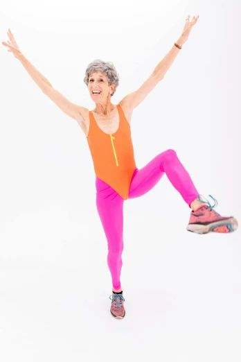 a woman doing a yoga pose against a white background, by Pamela Drew, happening, in spandex suit, she is about 7 0 years old, neon colored suit, wearing track and field suit