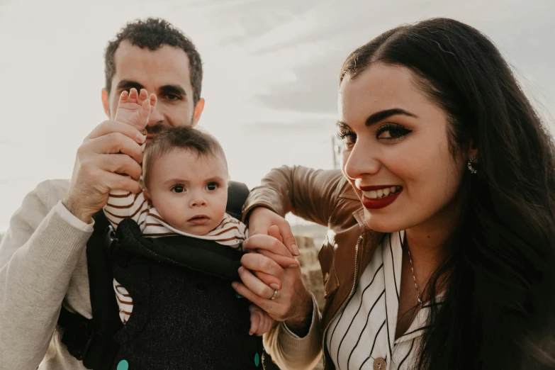 a man taking a picture of a woman holding a baby, a picture, by Matt Cavotta, pexels contest winner, avatar image, background image, dimples, close-up shoot