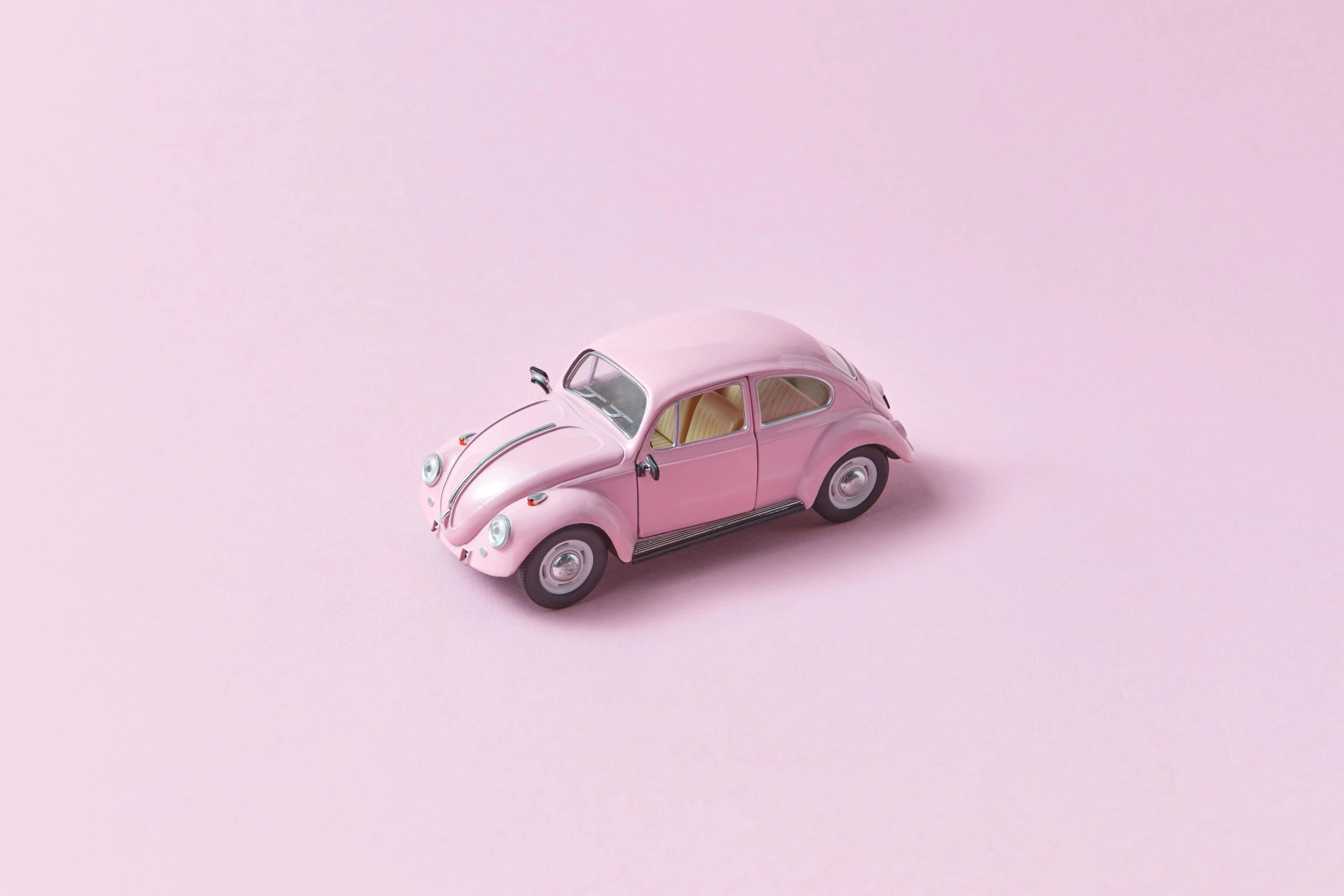 a pink toy car sitting on top of a pink surface, a 3D render, inspired by Chris LaBrooy, pexels contest winner, photorealism, beetle, light blush, 3/4 front view, jin kim