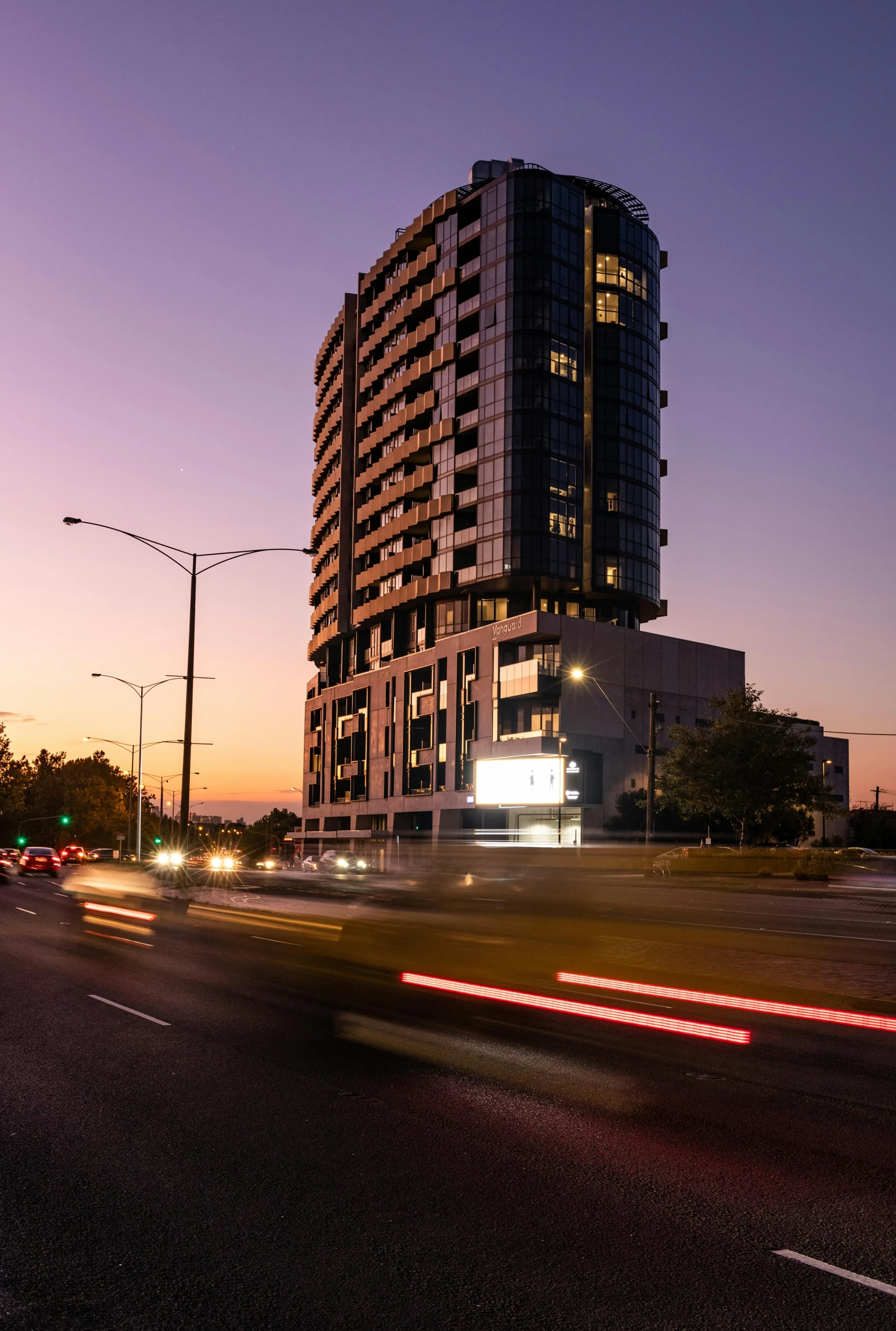 a very tall building sitting on the side of a road, in the evening, caulfield, zenith view, ultrawide image