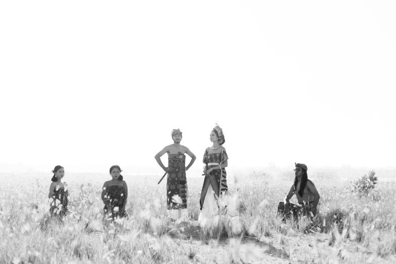 a black and white photo of a group of people in a field, by Kristian Zahrtmann, figuration libre, javanese mythology, warriors, summer morning, production photo