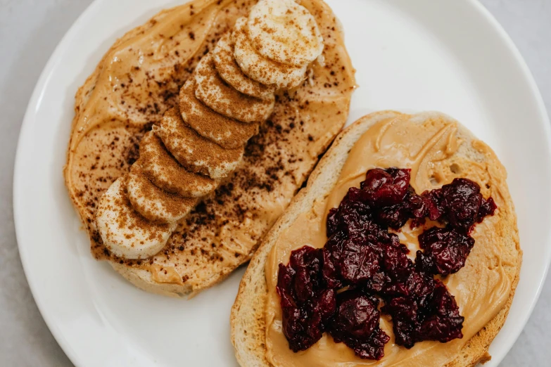 a peanut butter and cranberry sandwich on a plate, by Emma Andijewska, pexels contest winner, banana, humus, thumbnail, two tone