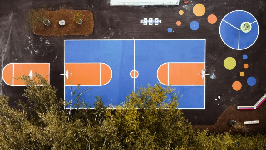 a basketball court painted on the side of a building, inspired by Paul Georges, unsplash contest winner, helicopter view, coloured in blueberra and orange, parks, game ready