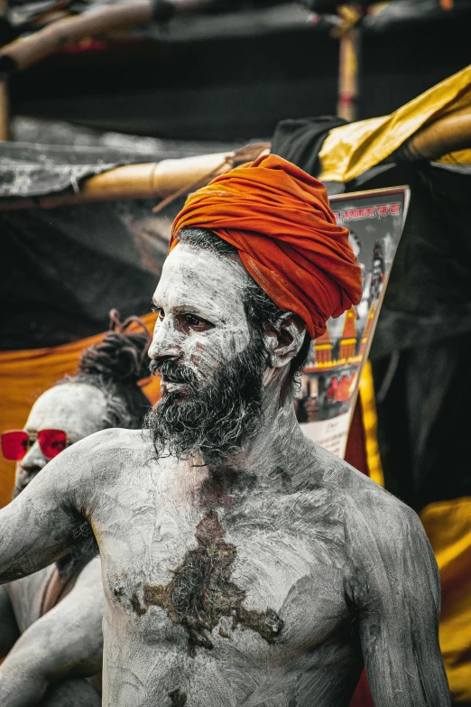 a man with white paint and a red turban, a black and white photo, pexels contest winner, hairy orange body, a pilgrim, covered with tar, a photo of a disheveled man