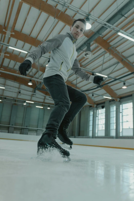 a man is skating on an ice rink, thumbnail, full dynamic colour, smooth technology, f / 2 0