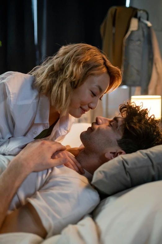 a man and woman laying in bed next to each other, riccardo scamarcio, sydney sweeney, wearing a white button up shirt, thumbnail