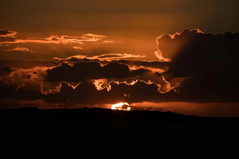 the sun is setting behind the clouds in the sky, by Jesper Knudsen, pexels contest winner, romanticism, orkney islands, fire on the horizon, silhouette :7, fan favorite