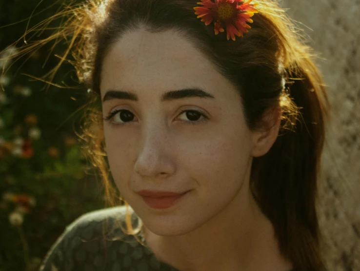 a woman with a flower in her hair, inspired by Lucia Peka, pexels contest winner, photorealism, perfectly lit. movie still, thick bushy straight eyebrows, yael shelbia, directional sunlight skewed shot