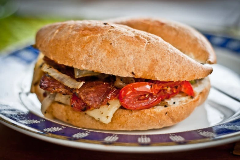 a close up of a sandwich on a plate, by Joe Bowler, renaissance, fan favorite, ratatouille style, bacon, loaves