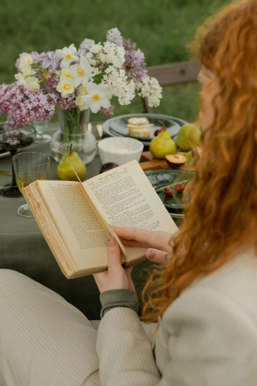 a woman sitting at a table reading a book, pexels contest winner, renaissance, midsommar style, low quality photo, full frame image, snacks