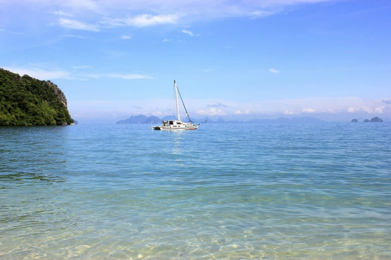 a boat floating on top of a body of water, white beaches, sailboat, clear blue skies, thumbnail