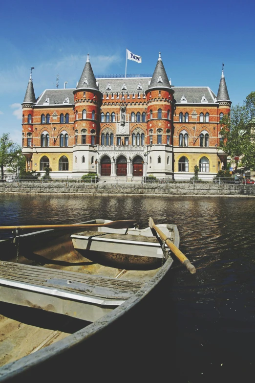 a boat that is sitting in the water, inspired by Johan Christian Dahl, unsplash, art nouveau, old building, square, high-quality photo, commercially ready