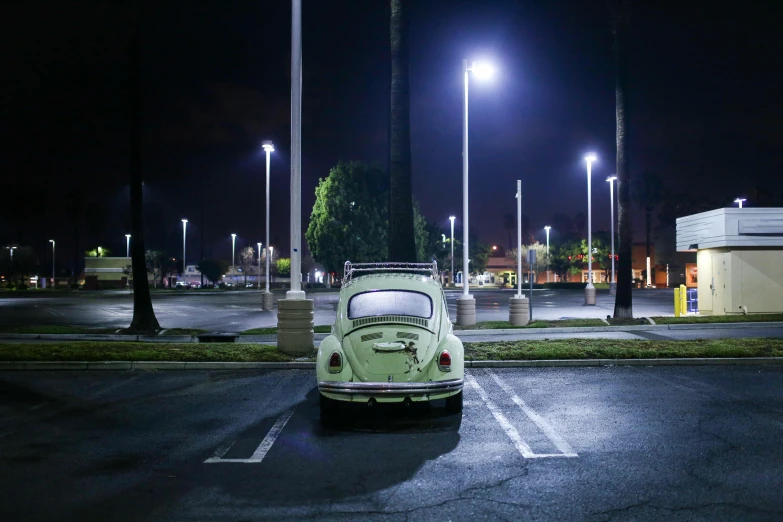 an old green car in a parking lot