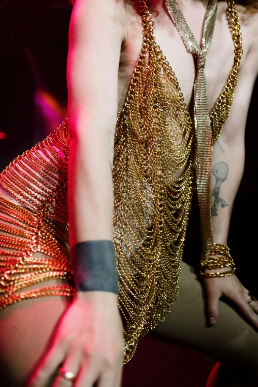 woman in sequin dress and tattoos on performing