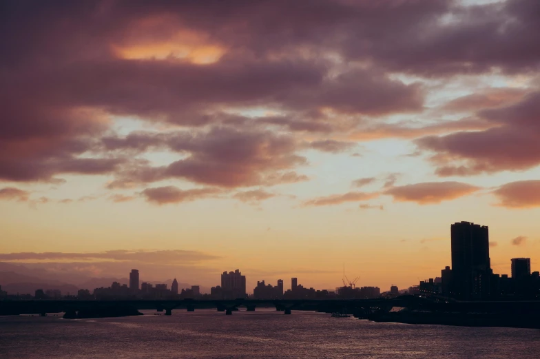 a city view at sunset, as seen from the bay