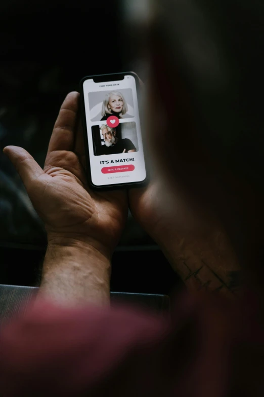 a close up of a person holding a cell phone, tinder profile, dark grey haired man, couple, 2019 trending photo