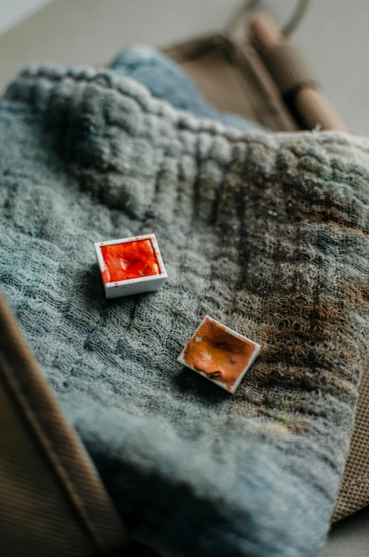 two square pins in the center of a blue towel