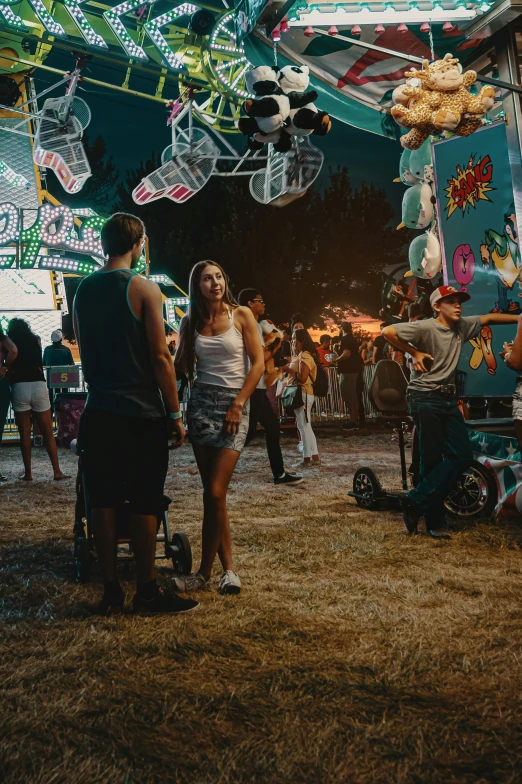 a couple of people that are standing in the dirt, poster art, by Matt Cavotta, pexels contest winner, happening, summer festival night, a busy arcade, beautiful girl, wide long shot