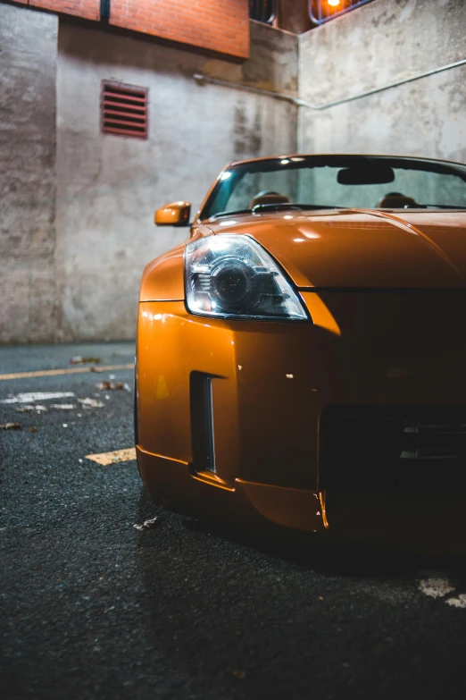 the front end of a sports car in an empty garage