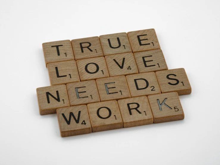 wooden scrabbles spelling true love needs work, a picture, by Emma Andijewska, studio quality, medium, thumbnail, 8 h